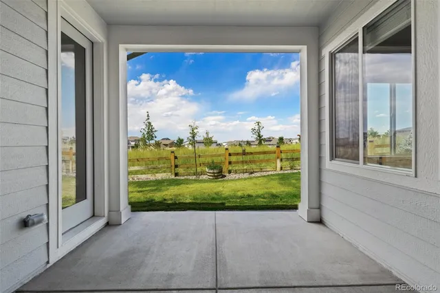 a view of a back yard from a corridor