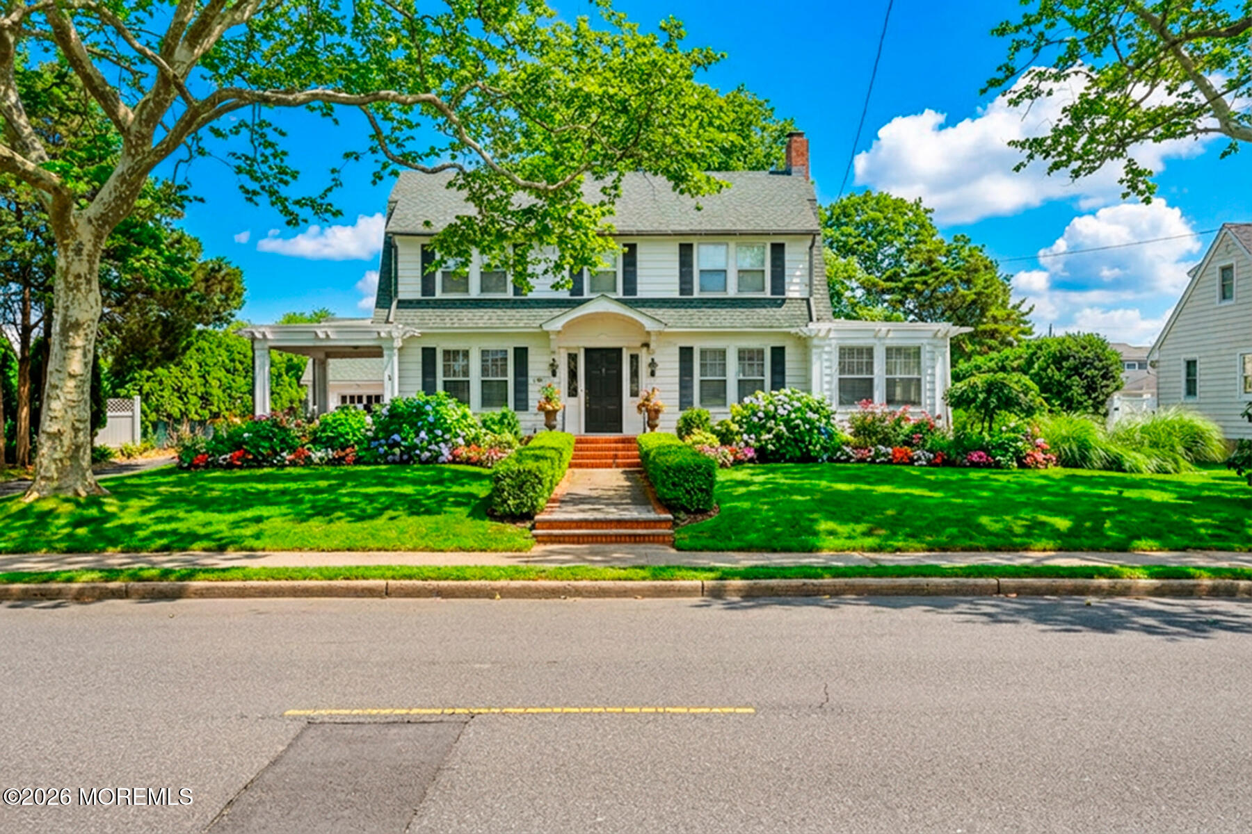 340 East Main Street Manasquan, NJ 08736 - Photo 11 of 46 a front view of a house with a garden and plants