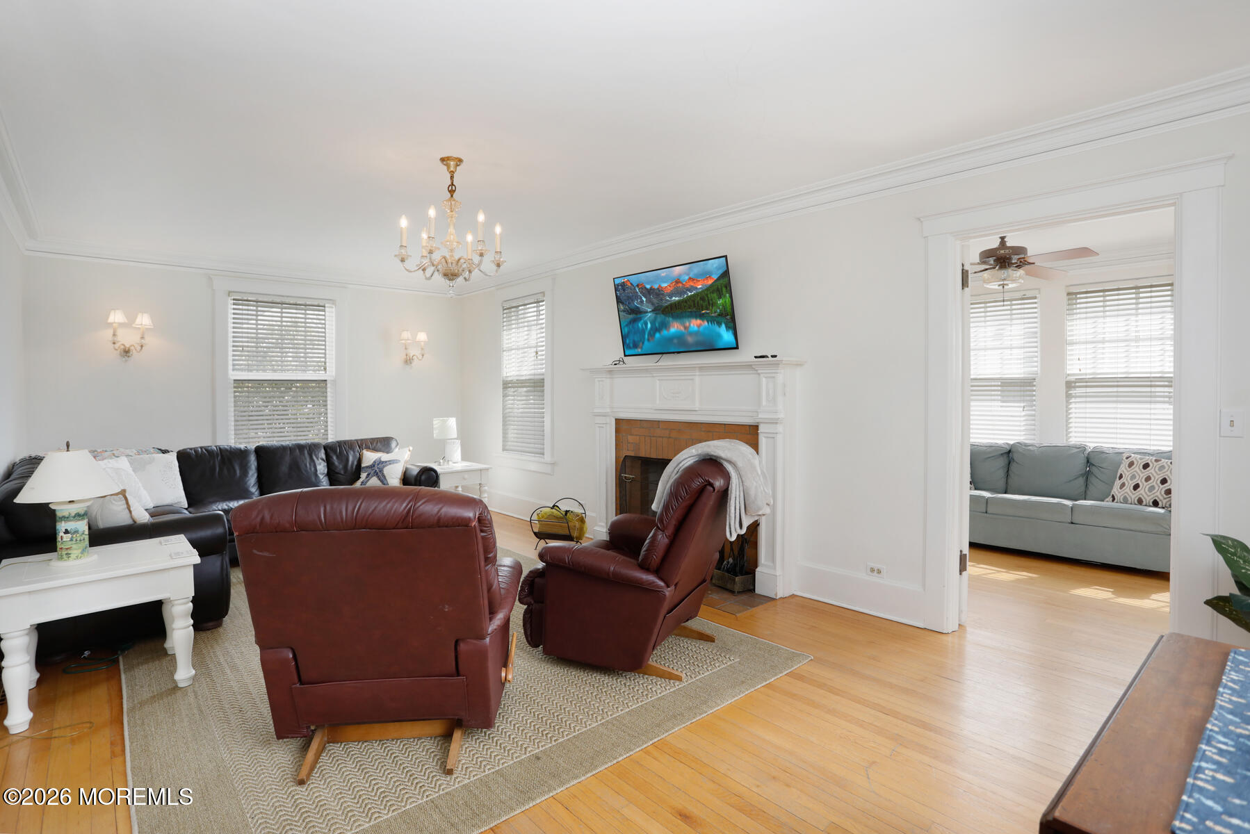 340 East Main Street Manasquan, NJ 08736 - Photo 15 of 46 a living room with furniture a fireplace and a chandelier