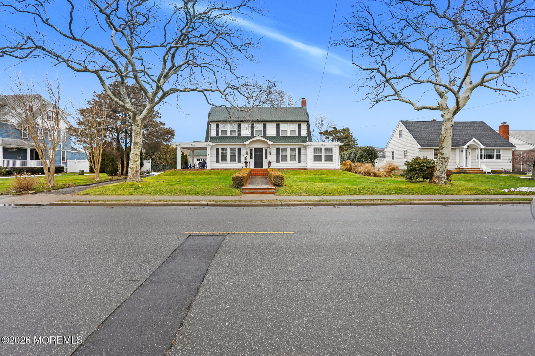 340 East Main Street Manasquan, NJ 08736 - Photo 7 of 46 a front view of a house with a yard and trees