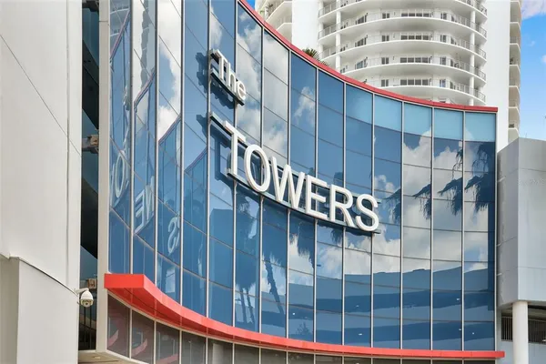 a view of staircase with railing and a chandelier
