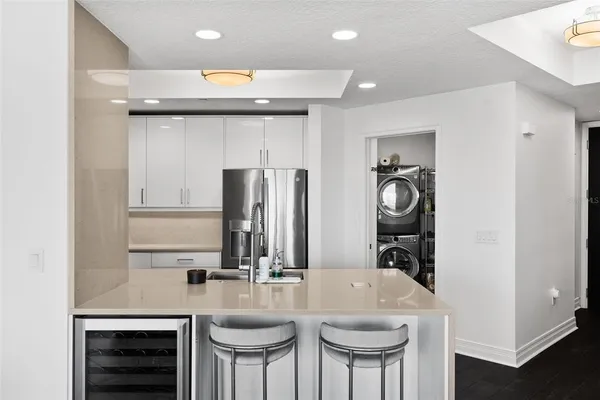 a kitchen with refrigerator and cabinets