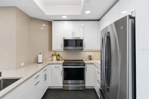 a kitchen with a refrigerator and a sink