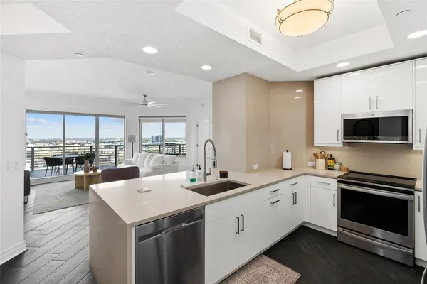 a kitchen with a sink stainless steel appliances and cabinets