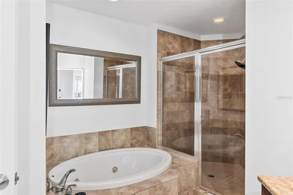 a bathroom with a bathtub and shower