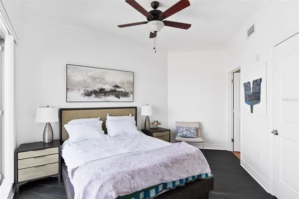 a bedroom with a bed and a painting on the wall