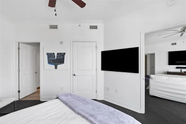 a bedroom with a bed and a flat screen tv