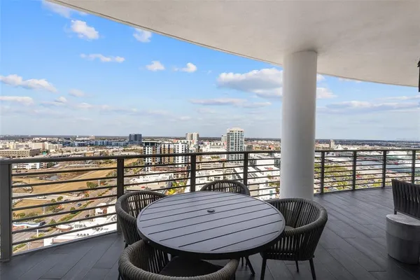 a view of a balcony with a table and chairs