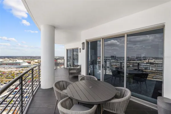 a balcony with table and chairs