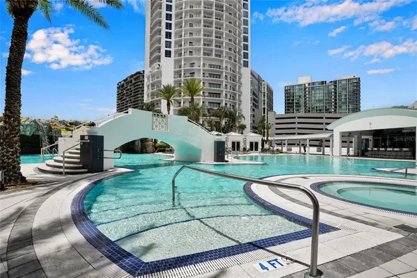 a view of a garden with tall buildings