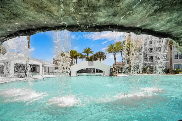 a view of a swimming pool with a patio and a yard
