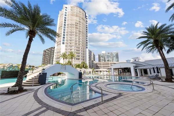 a view of a swimming pool with outdoor seating