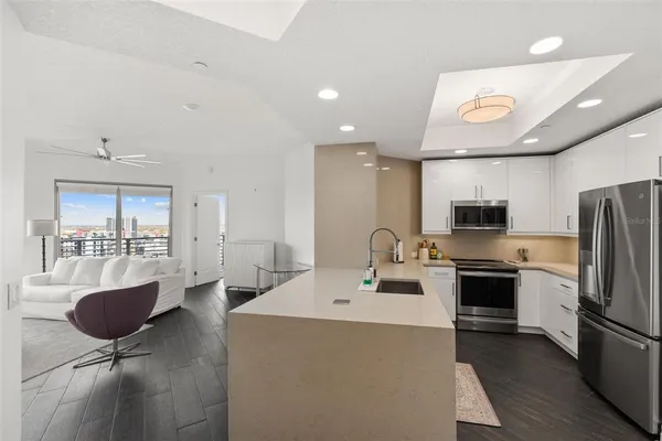 a kitchen with a sink stainless steel appliances and cabinets