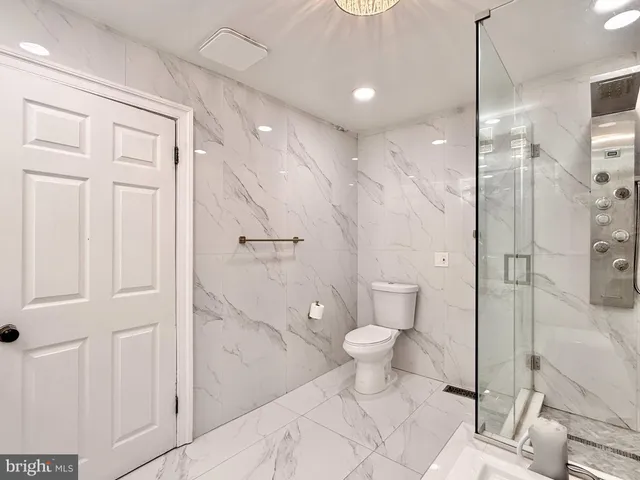 a bathroom with a toilet a sink and shower
