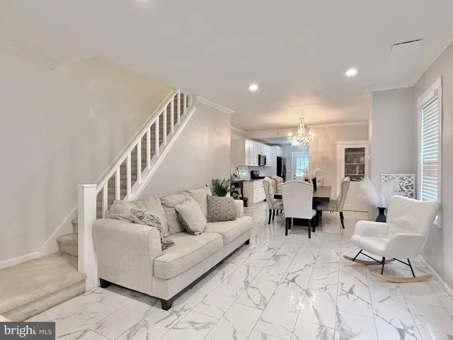 a living room with furniture and white walls