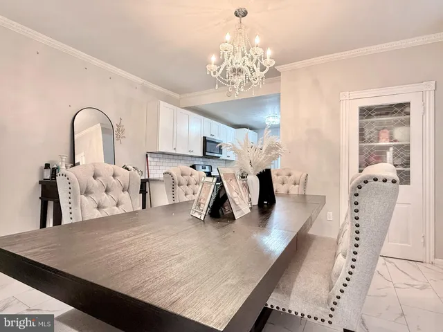 a living room with lots of furniture and chandelier