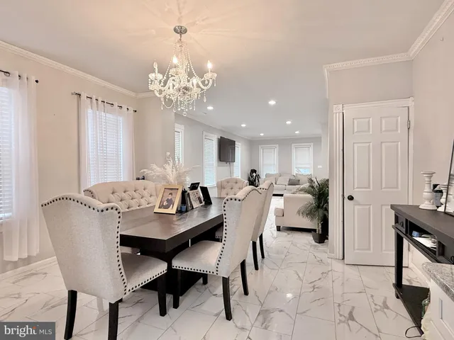a view of a dining room with furniture and chandelier