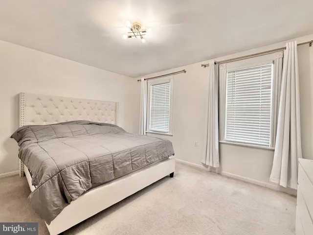 a spacious bedroom with a bed and a window