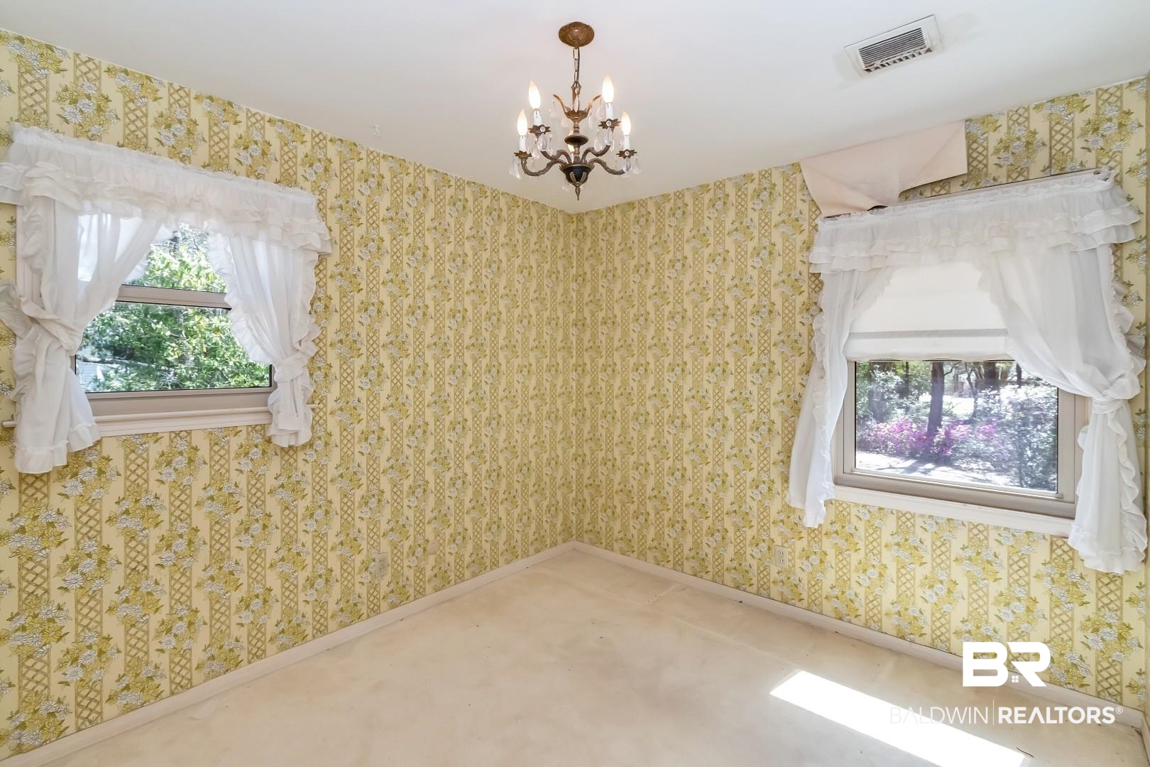 3715 South Conway Drive Mobile, AL 36608 - Photo 10 of 24 Spare room with wallpapered walls, a notable chandelier, baseboards, and visible vents