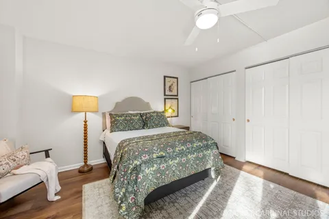 a bedroom with a bed and a lamp on dresser