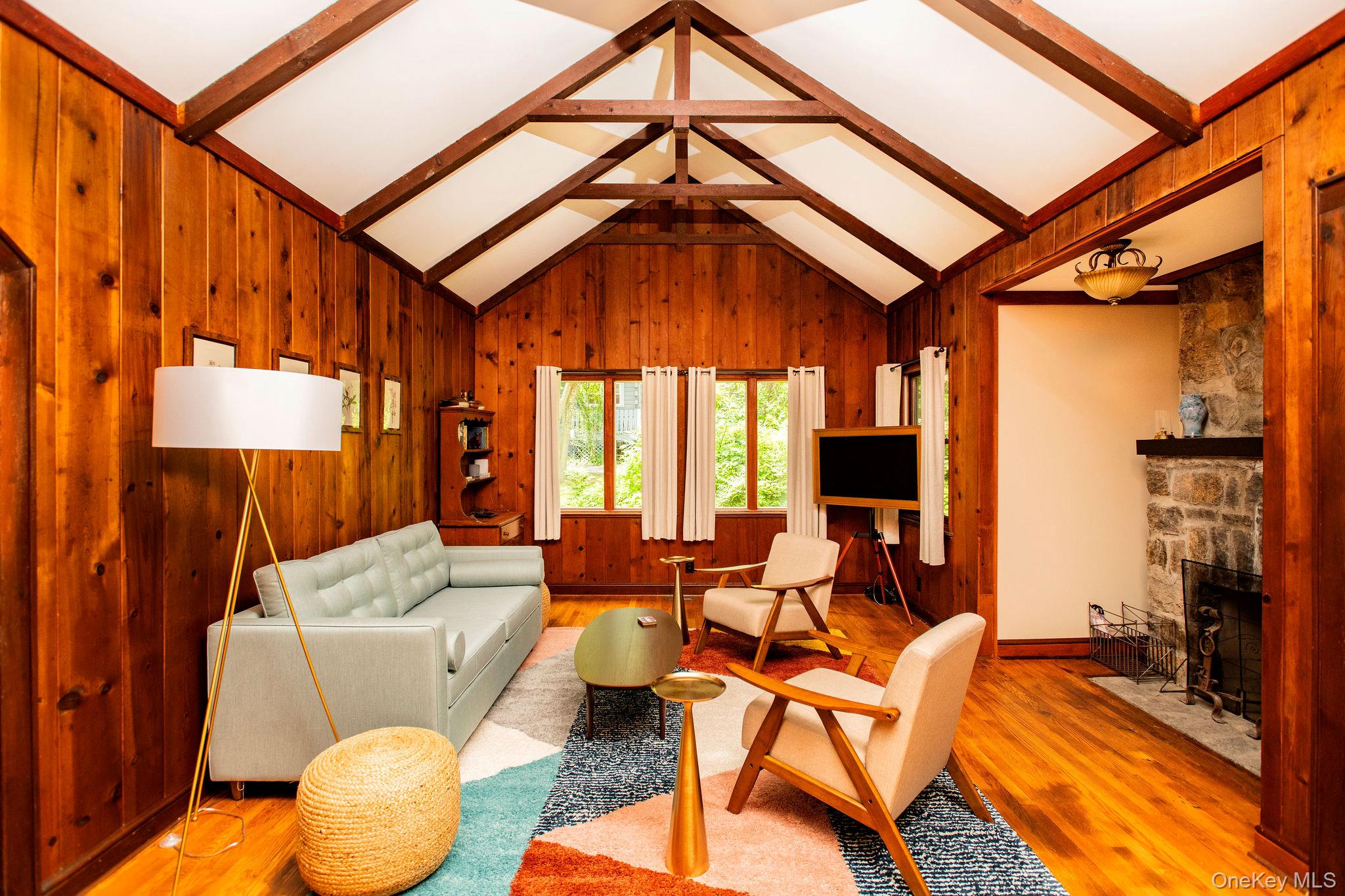 11 Locust Drive Cold Spring, NY 10516 - Photo 2 of 23 Spacious living room with working fireplace, pull out queen sofa bed, smart TV, and cozy modern furnishings.