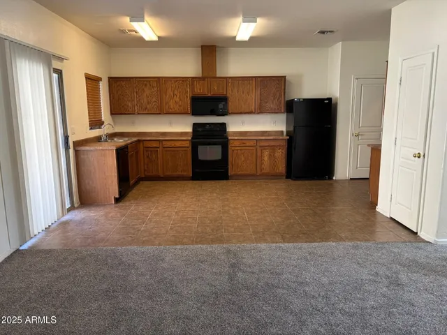 a kitchen with refrigerator a microwave and sink