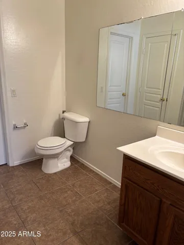 a bathroom with a sink a toilet and mirror
