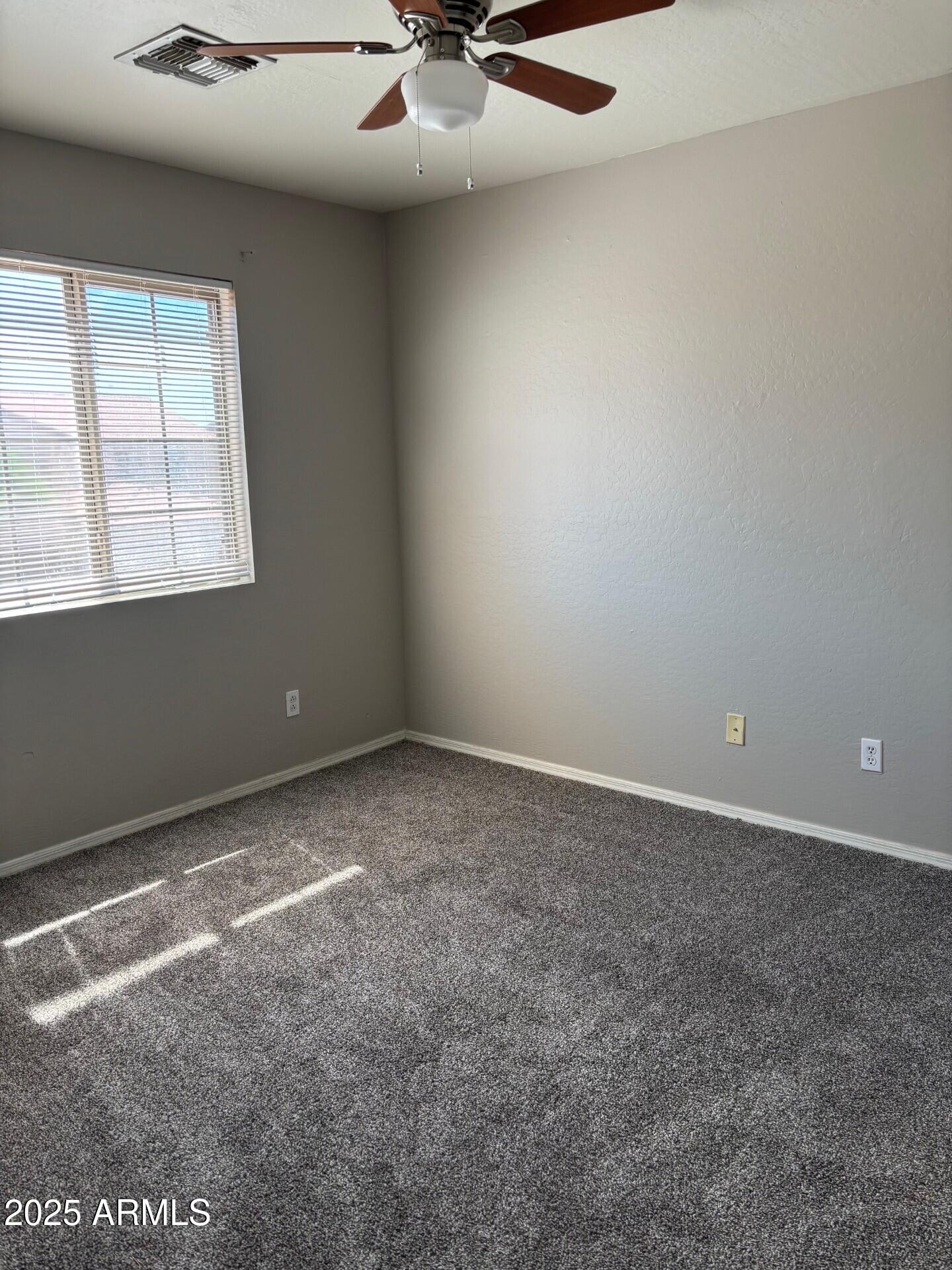7014 West Mercer Lane Peoria, AZ 85345 - Photo 6 of 14 an empty room with a window
