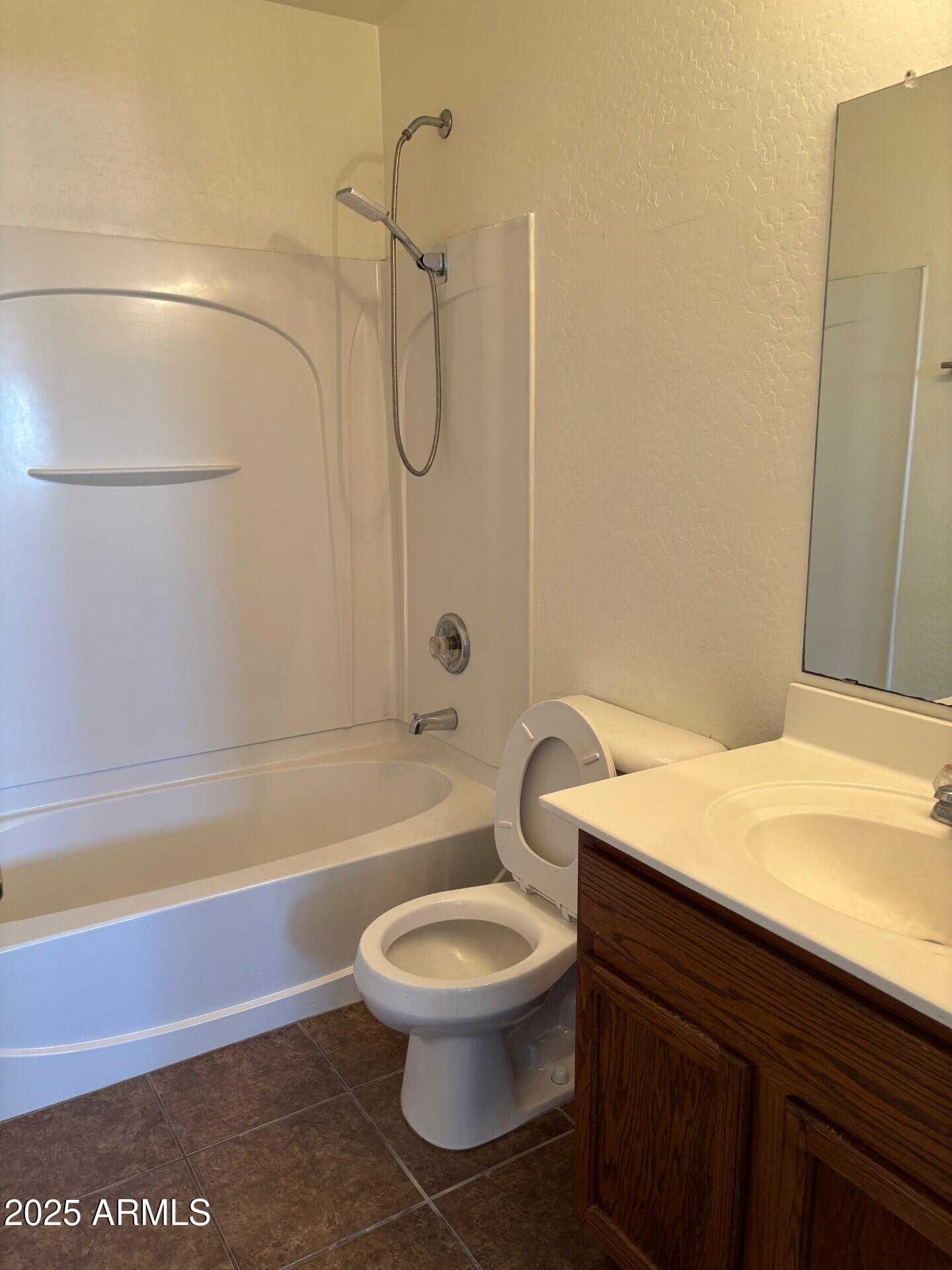 7014 West Mercer Lane Peoria, AZ 85345 - Photo 8 of 14 a bathroom with a toilet a sink and bathtub