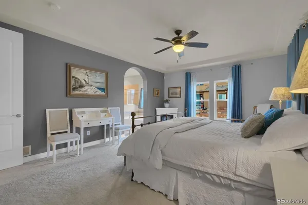 a bedroom with a bed and a chandelier