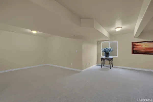an empty room with windows and furniture