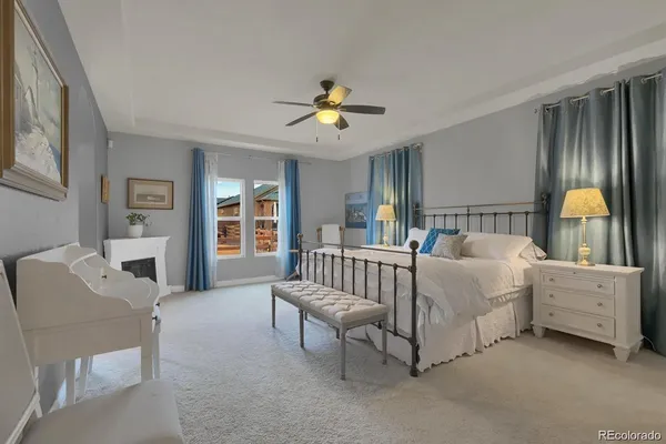 a spacious bedroom with a bed and a chandelier