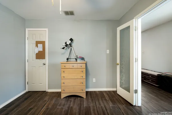 a room view with wooden floor and cabinet