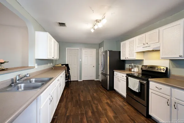 a kitchen with a sink dishwasher a stove and a refrigerator
