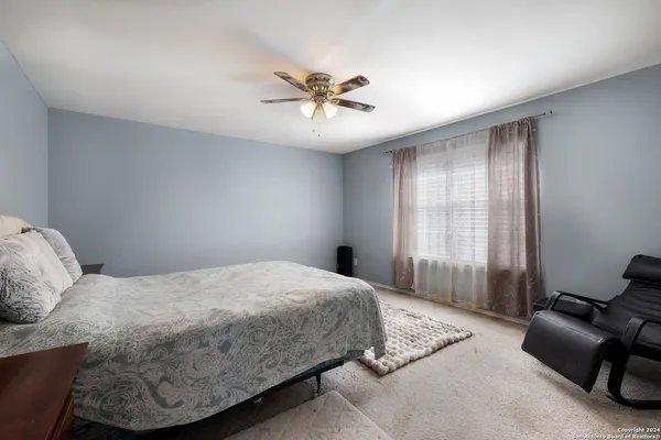 a bedroom with a bed and window