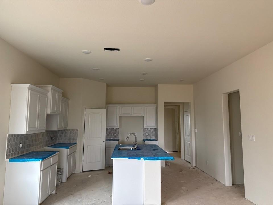 1217 Colca Drive Springtown, TX 76082 - Photo 3 of 9 a kitchen with stainless steel appliances a sink stove and cabinets