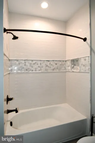 a bathroom with a bathtub and a toilet