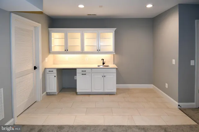 a kitchen with granite countertop a sink and cabinets