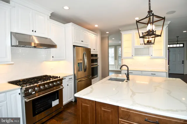 a view of a living room and kitchen with furniture floor to ceiling window