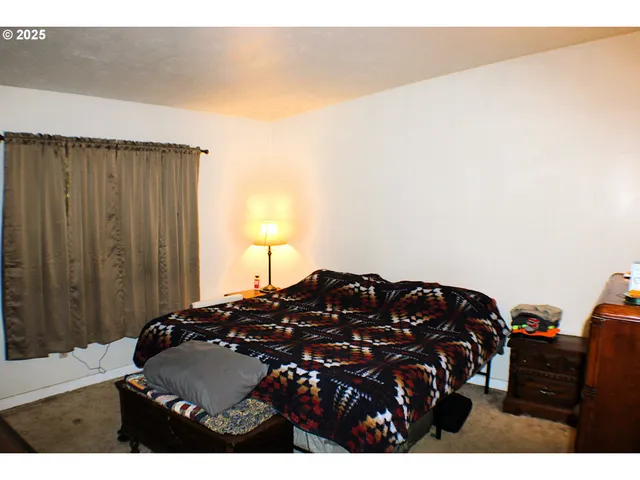 a bedroom with a bed and a dresser