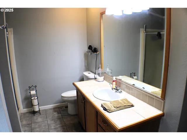 a bathroom with a sink vanity and a mirror