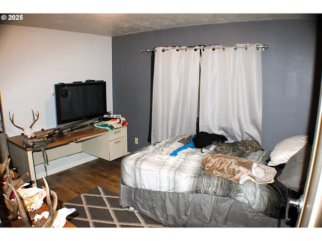 a bedroom with a bed and a flat screen tv