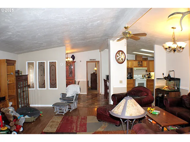 a living room with furniture a window and kitchen view