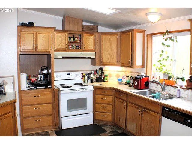 a kitchen with stainless steel appliances a stove a sink and a microwave