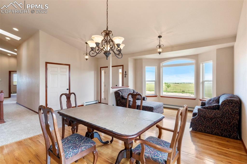 30103 Washington Road Calhan, CO 80808 - Photo 6 of 48 a view of a a dining room with furniture window and wooden floor
