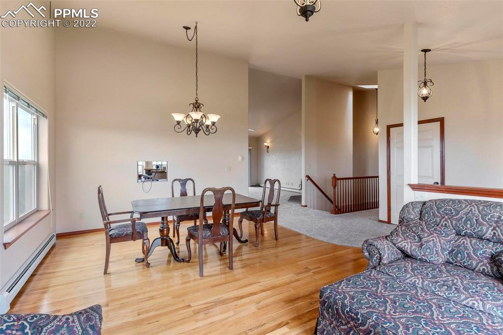 30103 Washington Road Calhan, CO 80808 - Photo 7 of 48 a view of a dining room with furniture and wooden floor