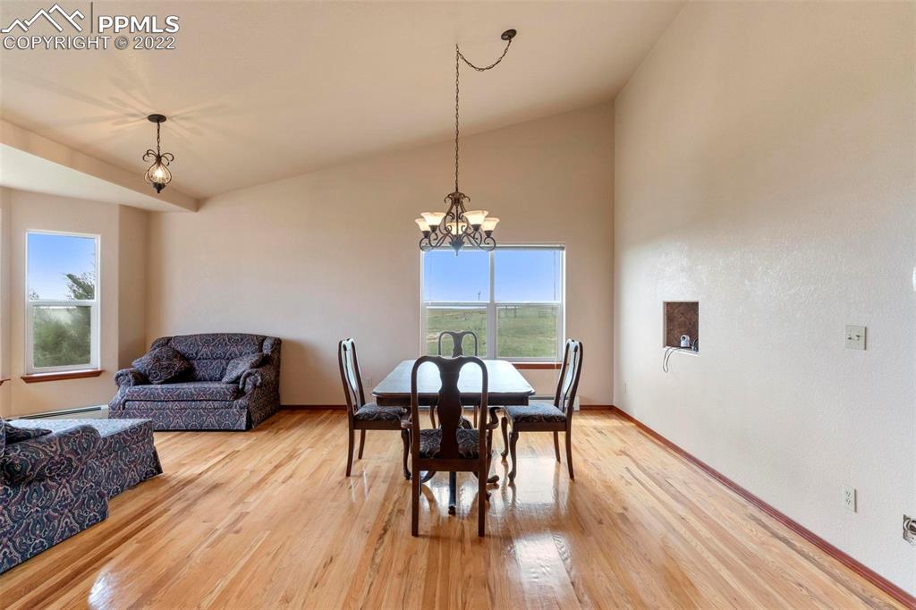 30103 Washington Road Calhan, CO 80808 - Photo 8 of 48 a view of a dining room with furniture and wooden floor