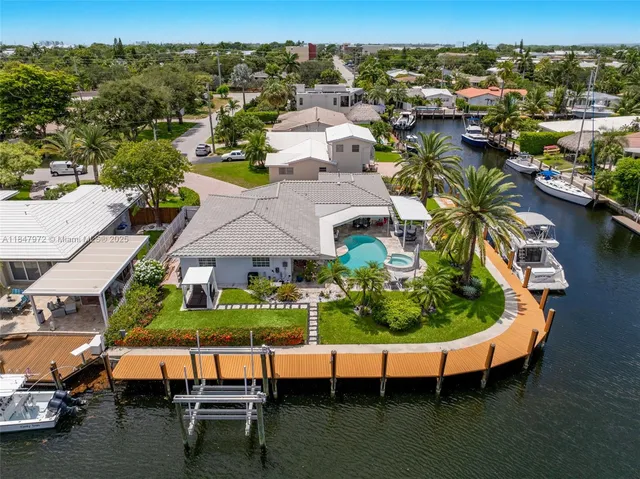 an aerial view of house with yard swimming pool and outdoor seating