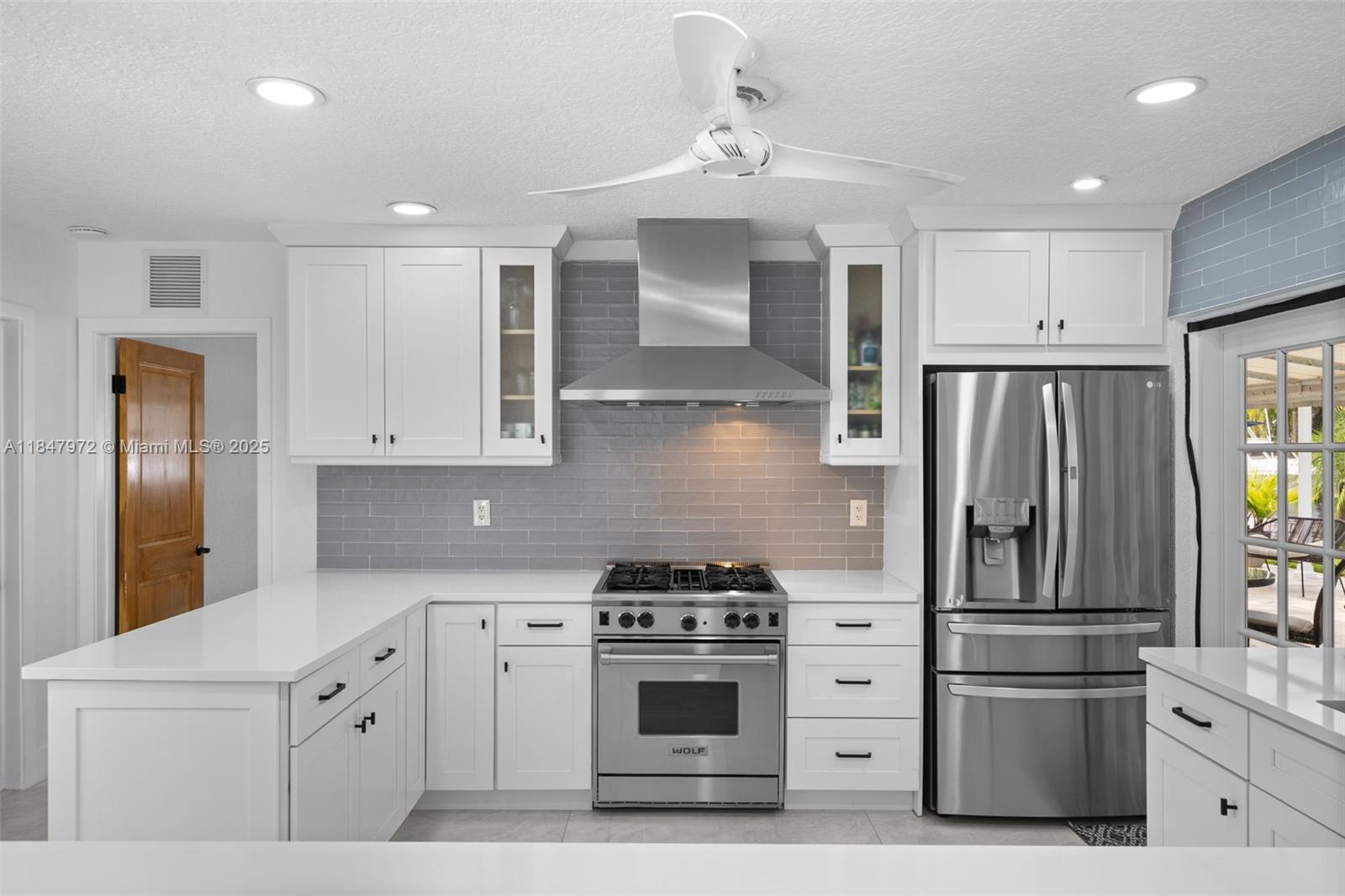 2681 Northeast 9th Court Pompano Beach, FL 33062 - Photo 16 of 58 a kitchen with cabinets stainless steel appliances and wooden floor
