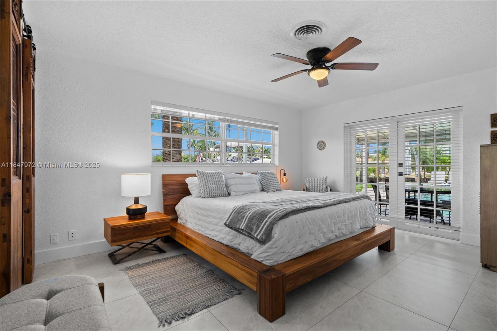 2681 Northeast 9th Court Pompano Beach, FL 33062 - Photo 21 of 58 a bedroom with a bed and window